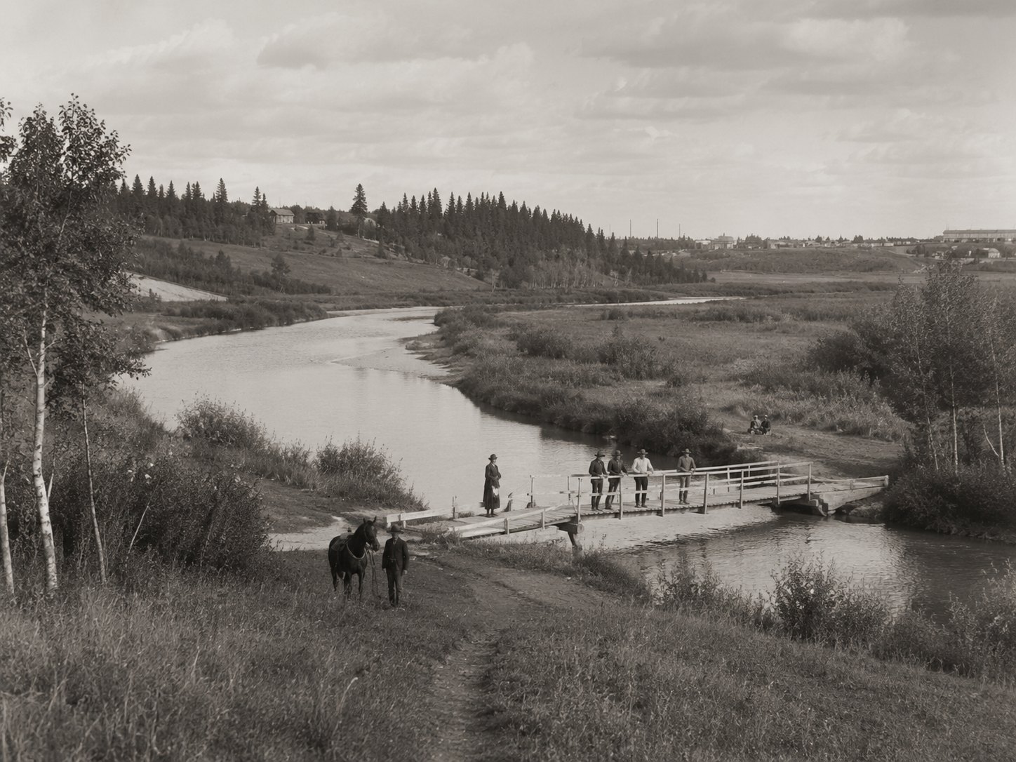 A footbridge over Bear Creek — the Muskoseepi valley that still runs green through the heart of the city.